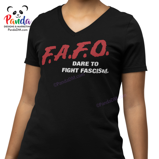 Close-up of a woman wearing a black ladies’ v-neck t-shirt with red and white FAFO DARE parody text that reads “Dare to Fight Fascism.” Design mimics the iconic 90s DARE shirts.