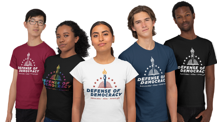 diverse group of people wearing Defense of Democracy t-shirts in various colors and styles including Veterans Defending Democracy, Students, Faith Leaders and more