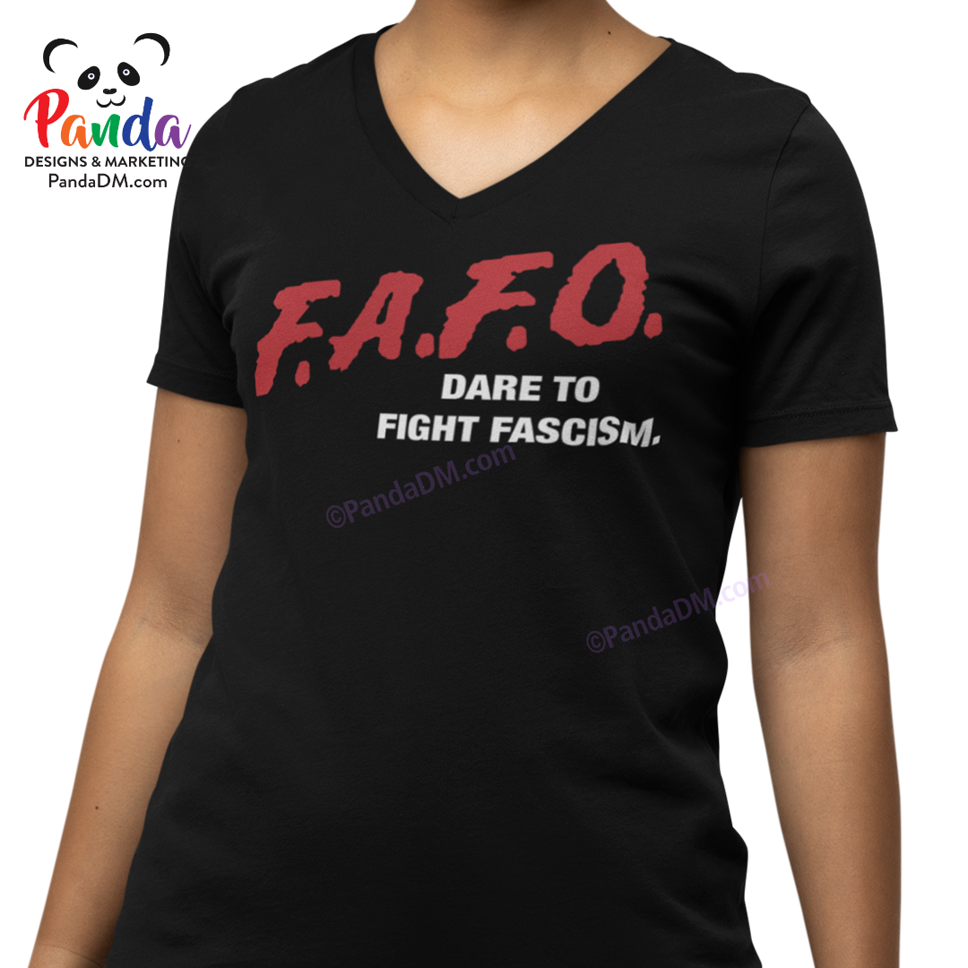 Close-up of a woman wearing a black ladies’ v-neck t-shirt with red and white FAFO DARE parody text that reads “Dare to Fight Fascism.” Design mimics the iconic 90s DARE shirts.