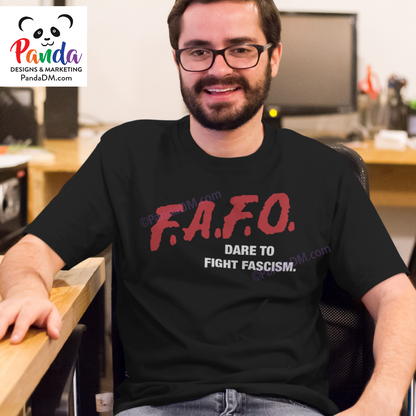 Man sitting indoors wearing a black unisex crew neck t-shirt with a red and white FAFO DARE parody design. The shirt reads “Dare to Fight Fascism” in a nostalgic 90s font.