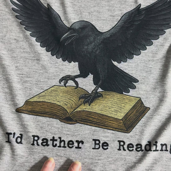 Video showing the F-Caw-F I'd Rather be reading original design sublimated onto atthetic heathered gray t-shirt