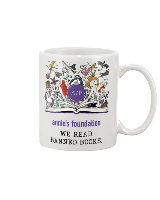 15 oz white ceramic mug with magical book artwork, Annie's Foundation logo and We Read Banned Books