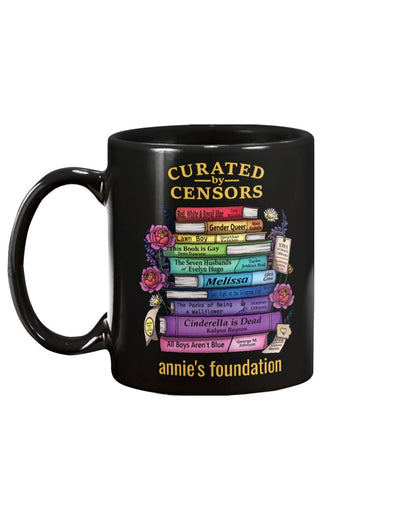 Annie's Foundation 15 oz black mug with Curated by Censors artwork featuring the titles of banned books